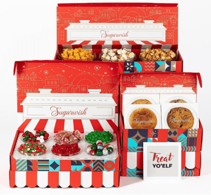 Festive red holiday gift boxes filled with cookies and candies.