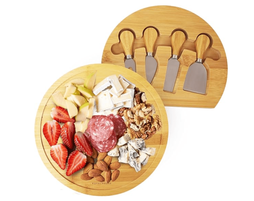Round bamboo charcuterie board with strawberries, cheese, nuts, and matching cheese knives.