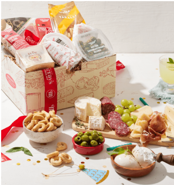 Gourmet Italian food gift basket with cheese, olives, cured meats, crackers, and wine.