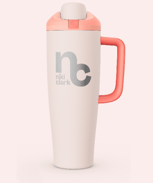 White insulated tumbler with pink handle and “nc niki clark” logo on the front.