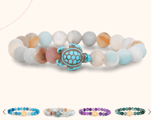 Pastel beaded bracelet with a turquoise turtle charm on a light background.